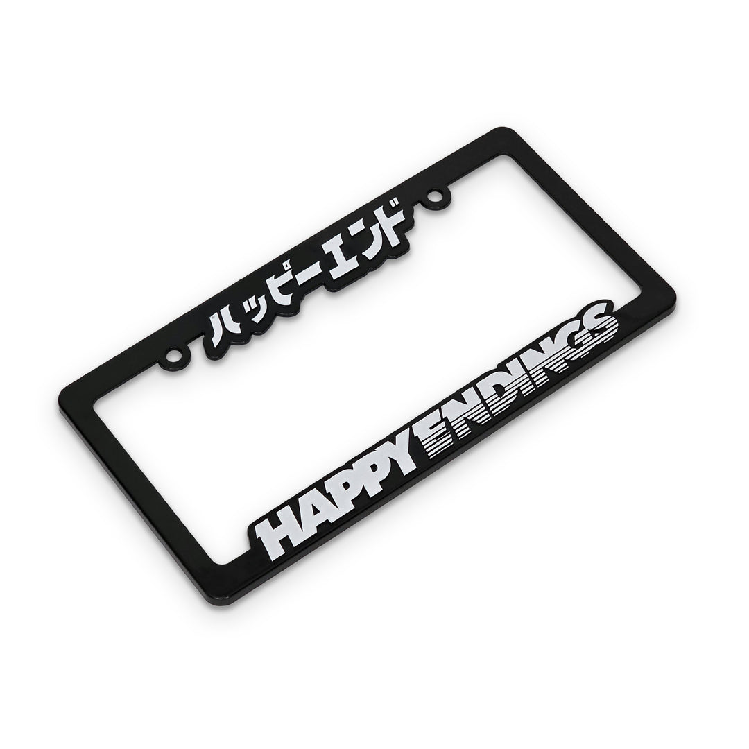 Black license plate frame with 'HAPPY ENDINGS' text on a white background