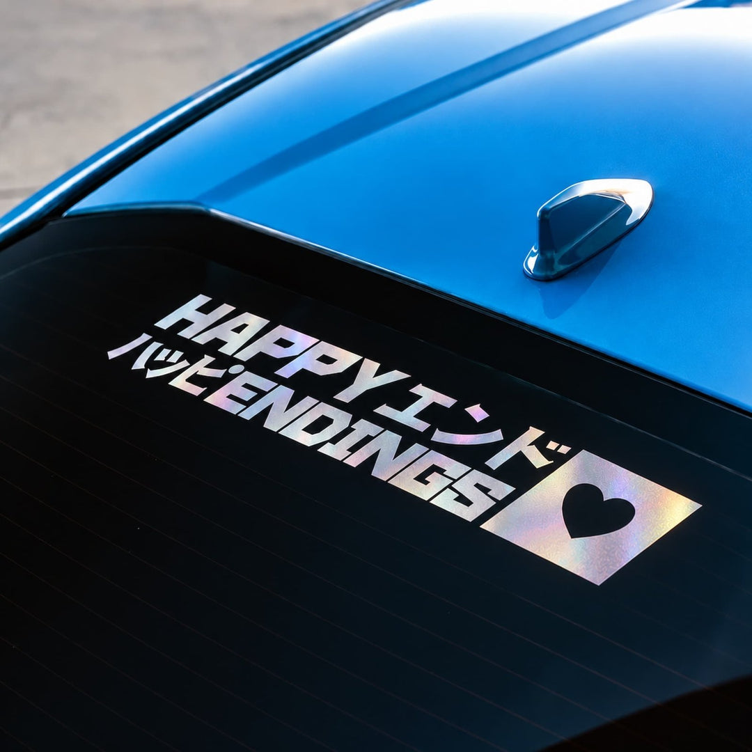 A car window decal that reads HAPPY ENDINGS in English and Japanese with a heart icon.