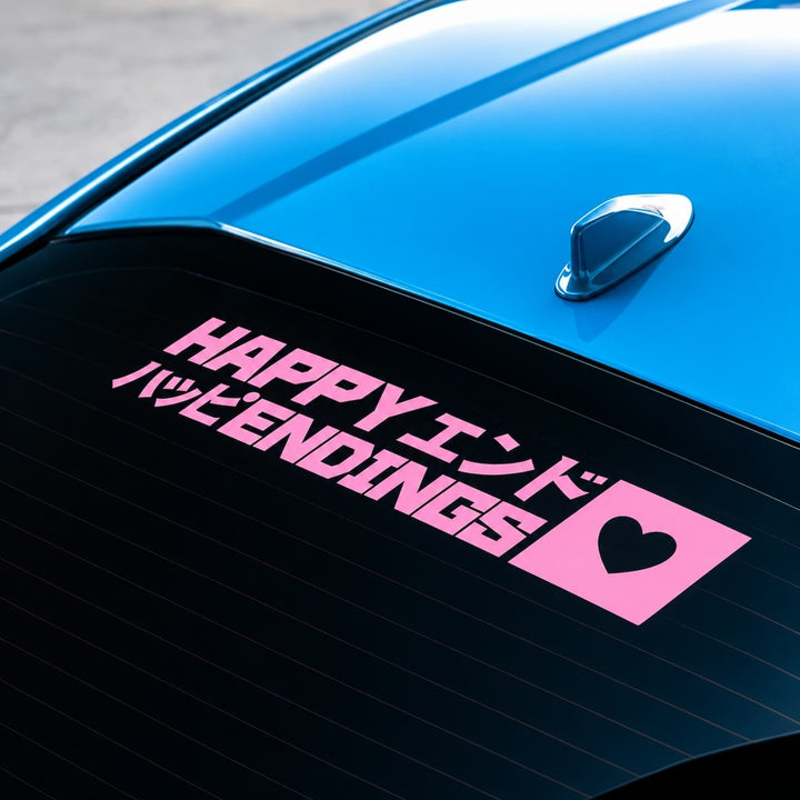 Pink HAPPY ENDINGS decal with Japanese text and a heart on a blue cars rear window.