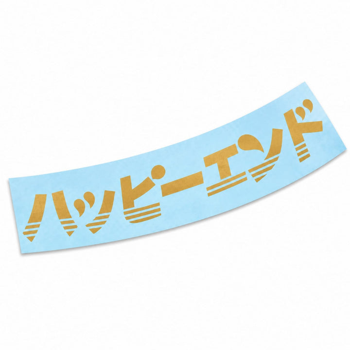 A light blue sticker with the gold Japanese text ハッピーエンド in a stylized font.