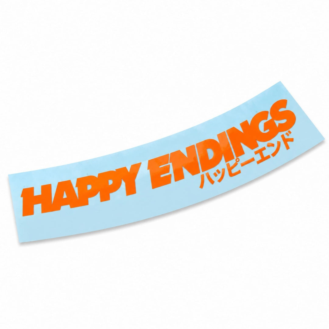 A light blue curved sticker with the orange text HAPPY ENDINGS and Japanese characters.