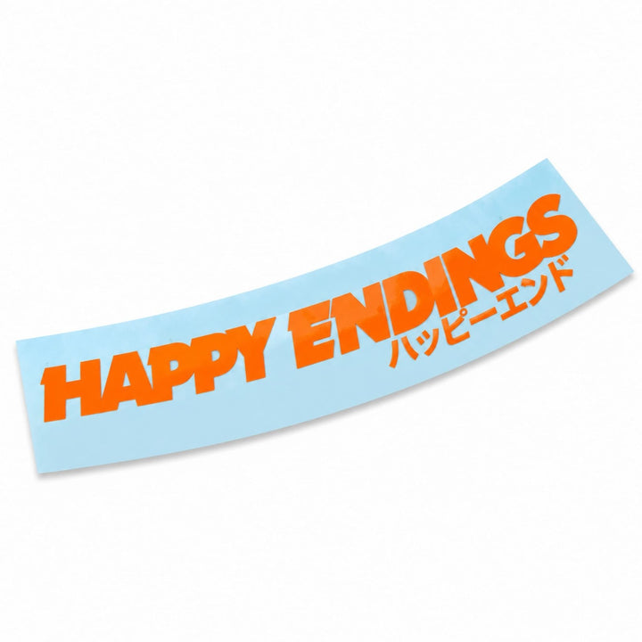 A light blue curved sticker with the orange text HAPPY ENDINGS and Japanese characters.