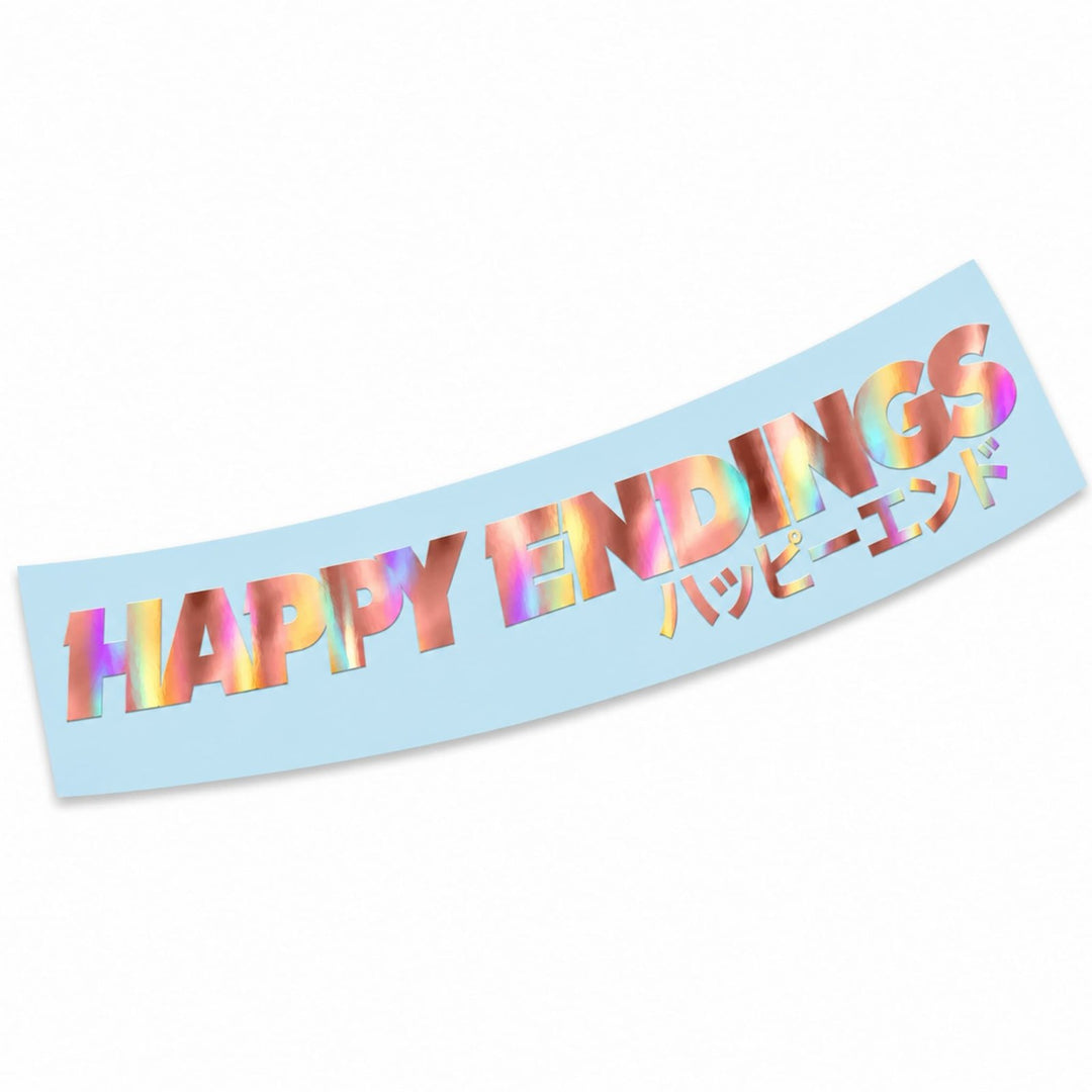 Holographic text reading HAPPY ENDINGS and ハッピーエンド on a light blue background.