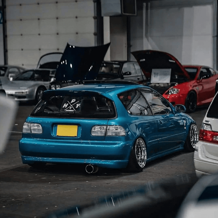 Blue car with open hood at a car show