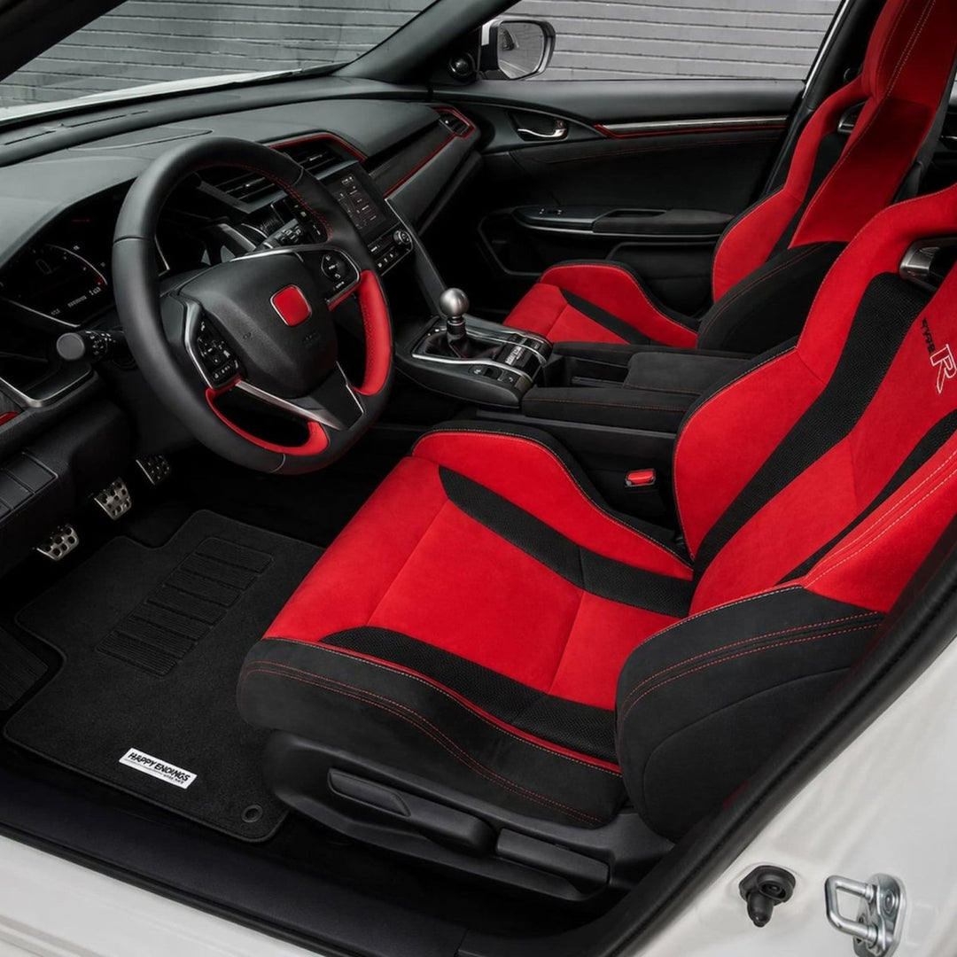 Red and black car interior, sporty bucket seats, manual gear shift, and detai...