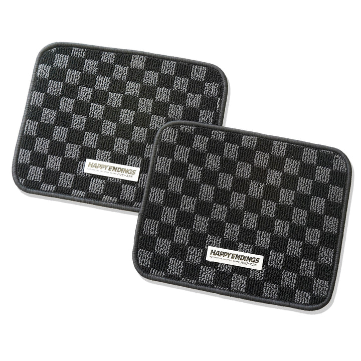 Two rectangular mats with a black and gray checkerboard pattern and HAPPY ENDINGS labels in the center.