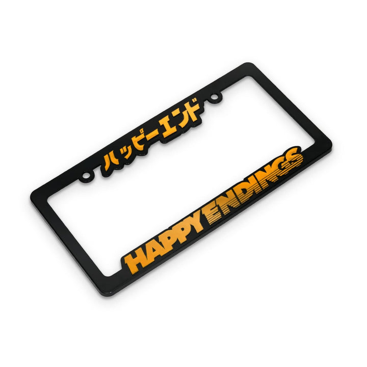 Black license plate frame with HAPPY ENDINGS and Japanese text in bold yellow lettering.
