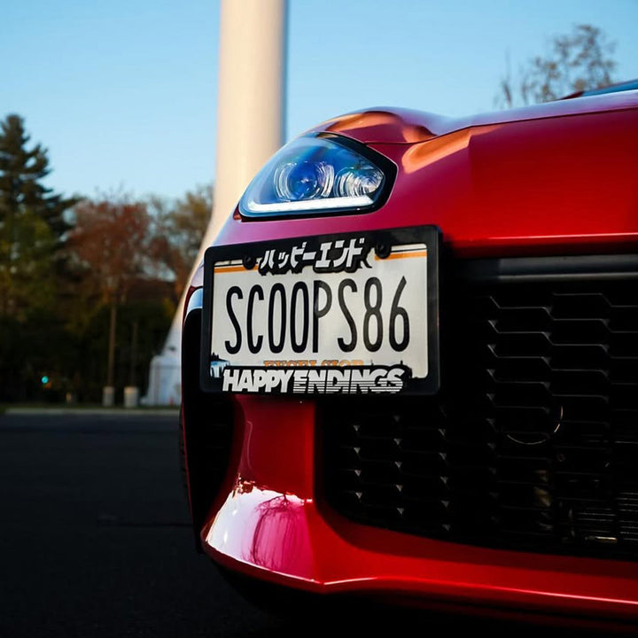 License Plate Frame - White (Black Frame) - Happy Endings - Automotive & Lifestyle Brand