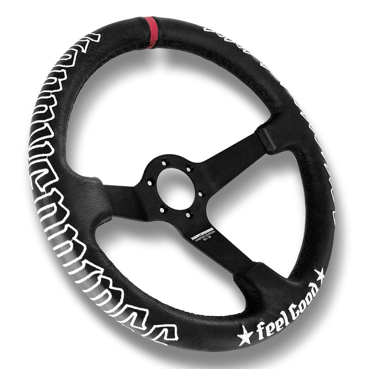 Black steering wheel with white text and red accents on a white background