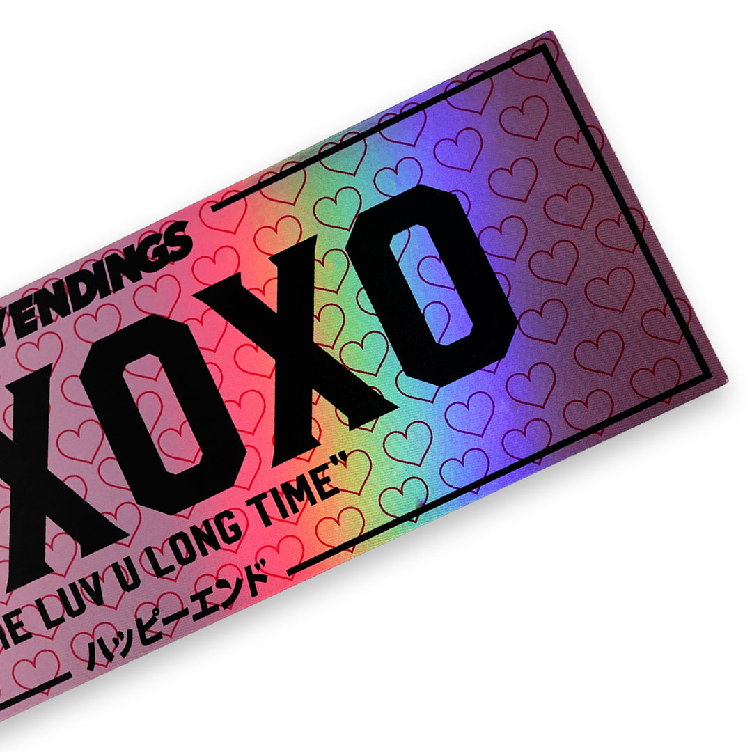 Holographic XOXO windshield banner sticker by Happy Endings featuring pink heart pattern and black lettering