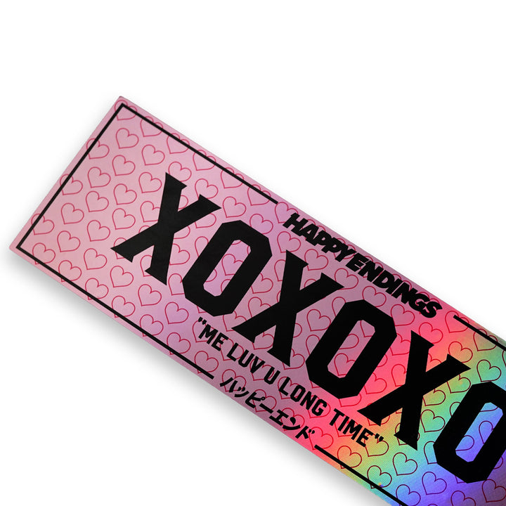 Holographic XOXO windshield banner sticker by Happy Endings featuring pink heart pattern and black lettering