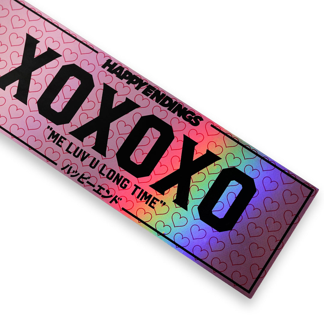 Holographic XOXO windshield banner sticker by Happy Endings featuring pink heart pattern and black lettering