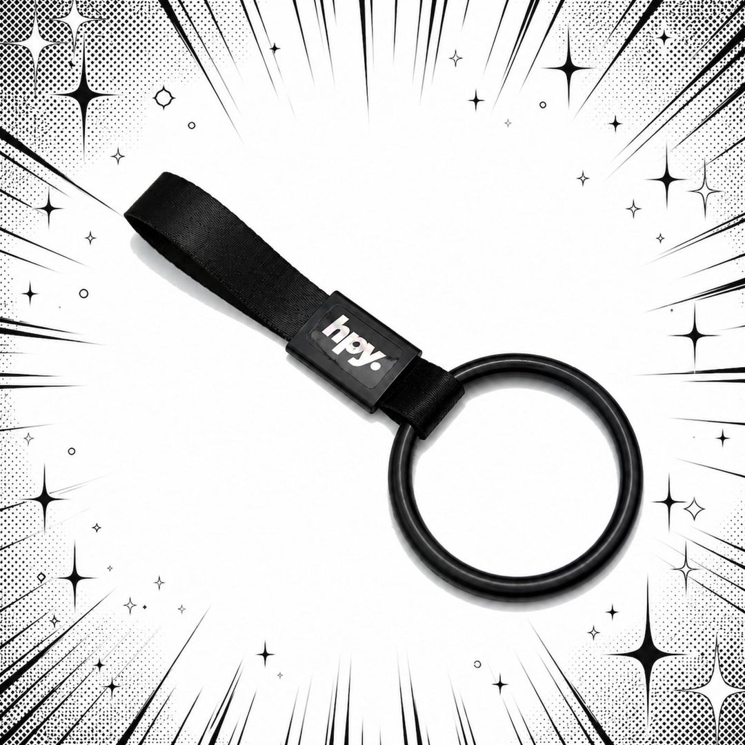 Black keyring with hpy! label on a starburst comic-style black and white back...