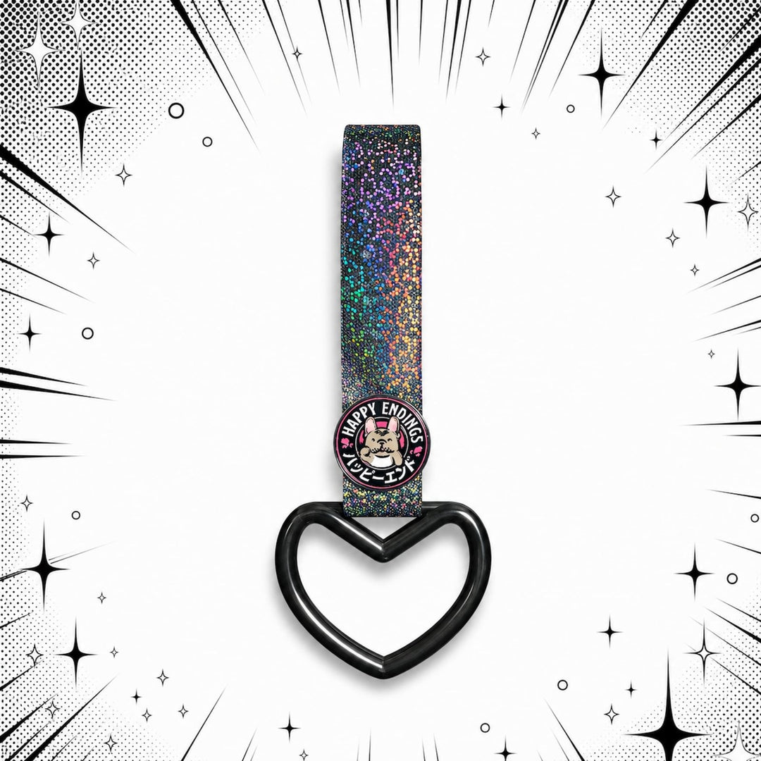 Glittery strap with heart-shaped ring and a round Happy Ending pin on comic-s...