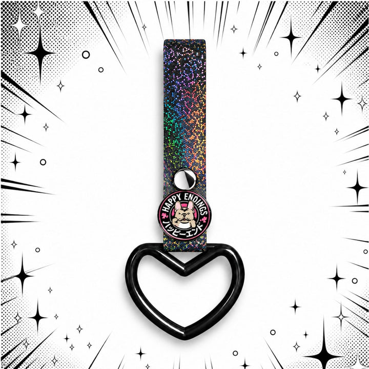 Glittery strap with heart-shaped ring and Happy Endings pin on comic-style background.
