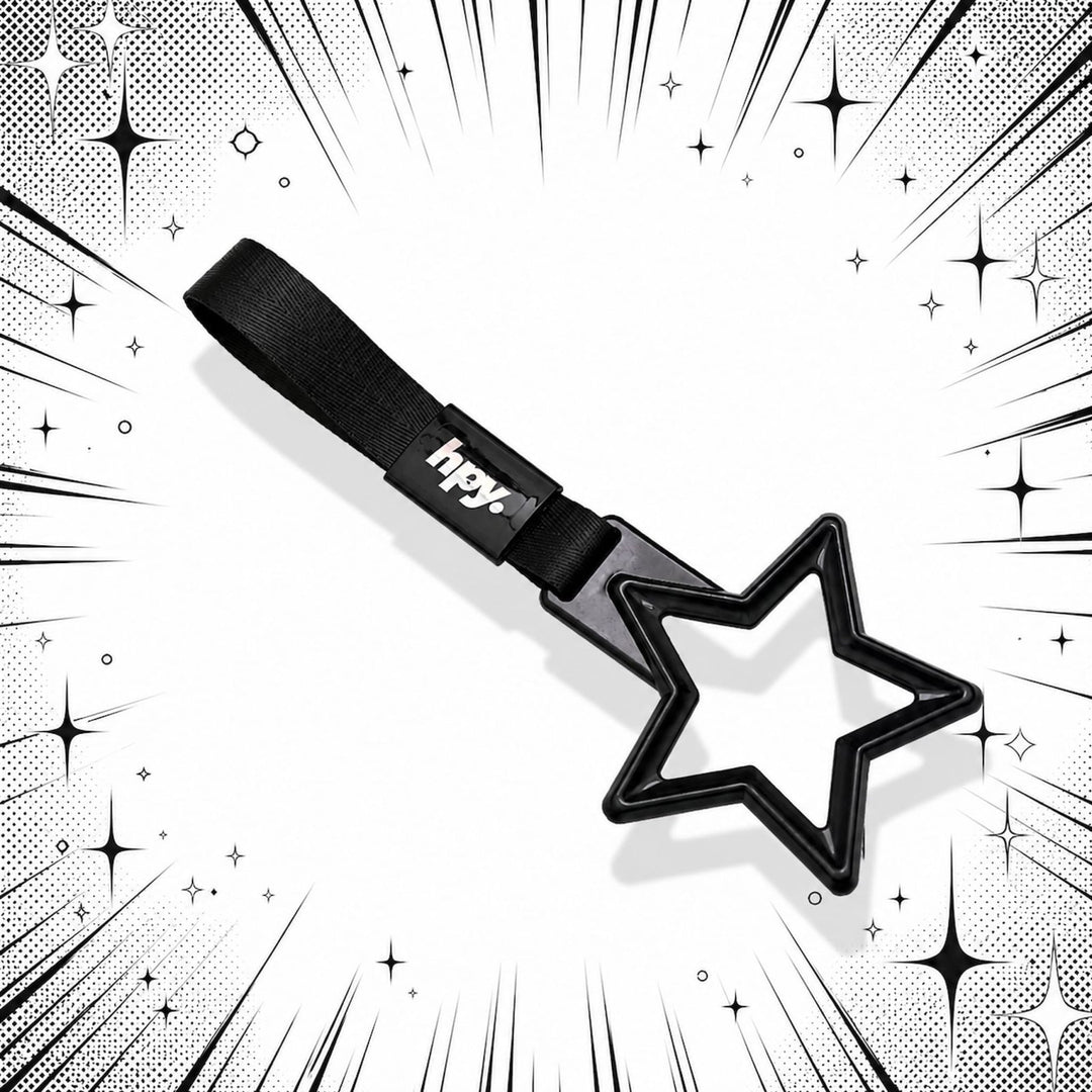 Black star-shaped wand with a strap, surrounded by comic-style black and whit...