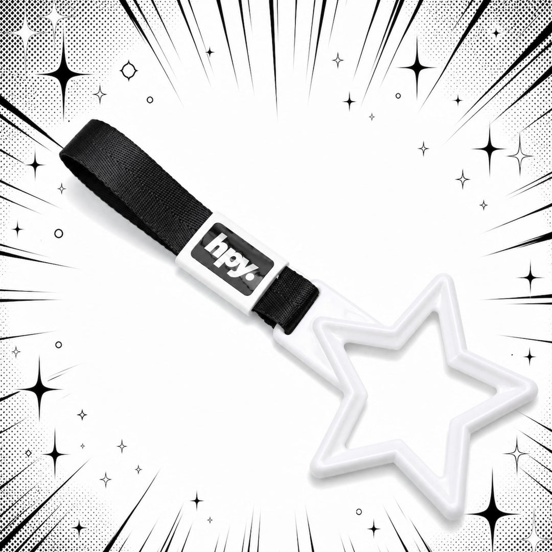 A white star-shaped keychain with a black hpy label, set against a comic-styl...