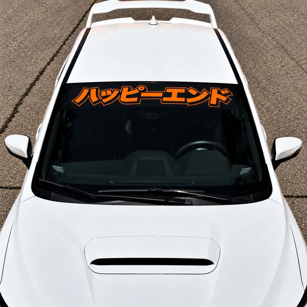 White car with an orange Japanese sticker on the windshield.