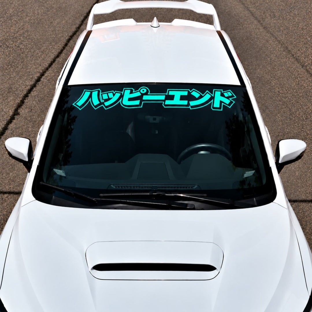 White car with turquoise Japanese text on the windshield.