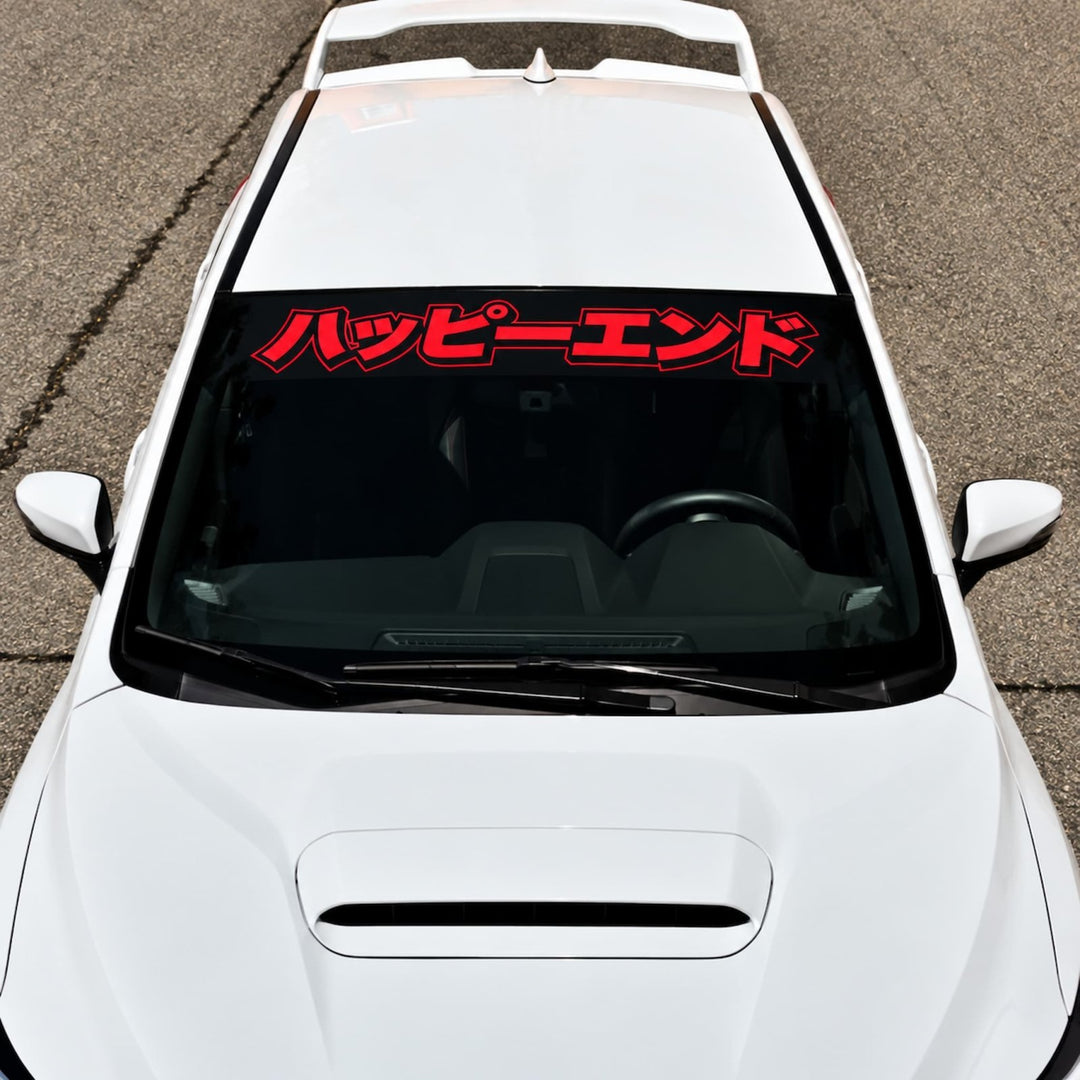 White car with a red Japanese text windshield decal.