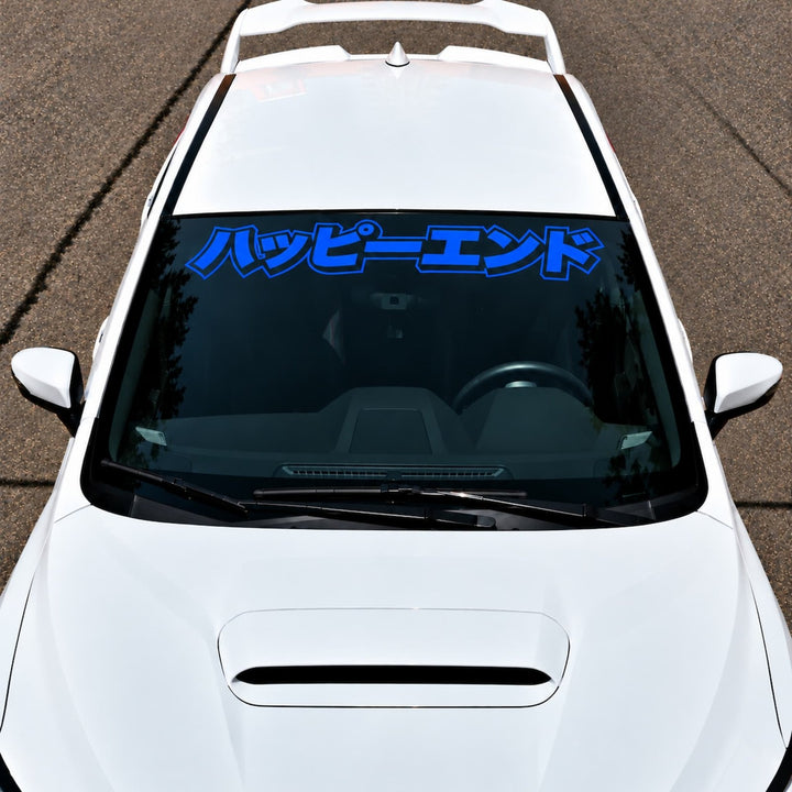 White car with a blue Japanese text decal across the top of the windshield.