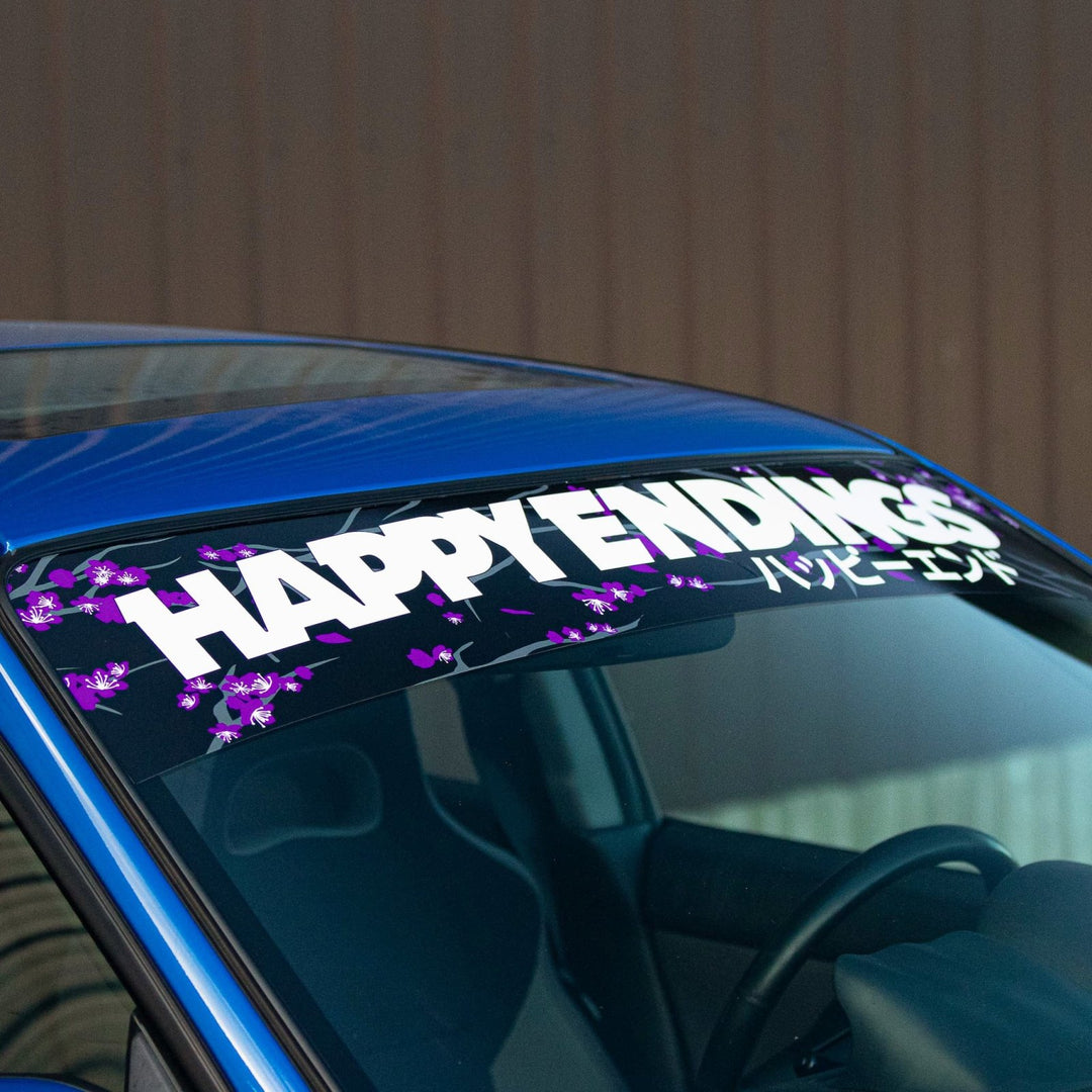 Happy Endings decal with flowers on blue car windshield.