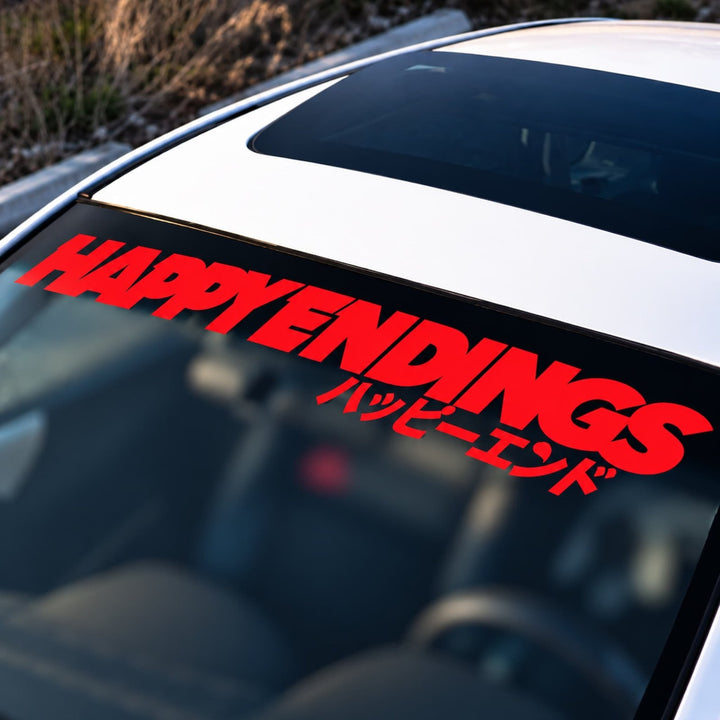 Red HAPPY ENDINGS text in English and Japanese on a car windshield.