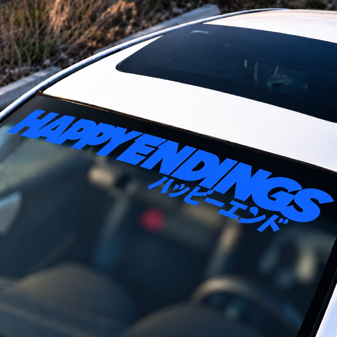 Blue HAPPY ENDINGS text and Japanese characters on a car windshield banner.