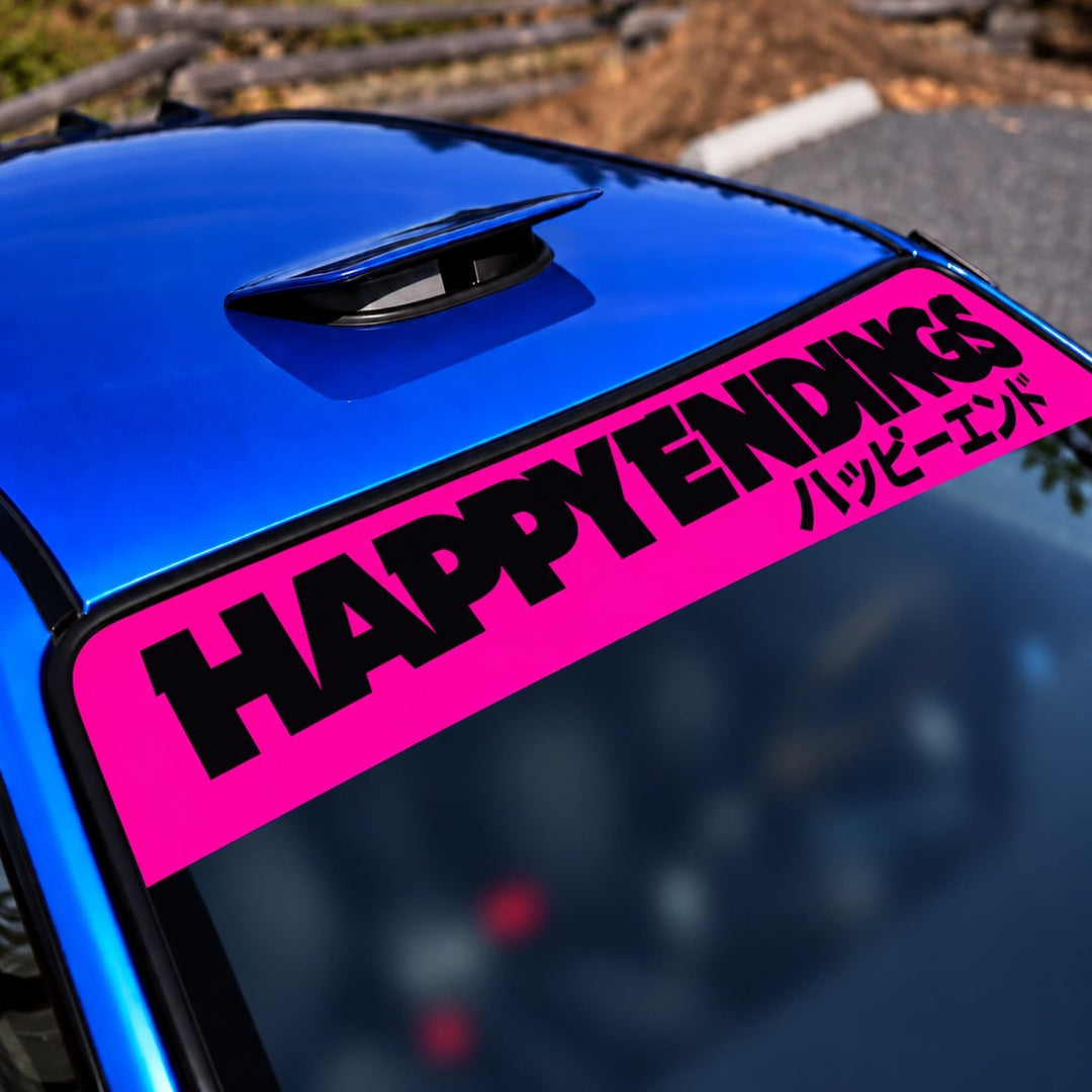 Blue car with a pink windshield banner reading HAPPY ENDINGS and Japanese text.
