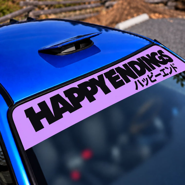 Purple HAPPY ENDINGS decal with Japanese text on a blue car windshield.