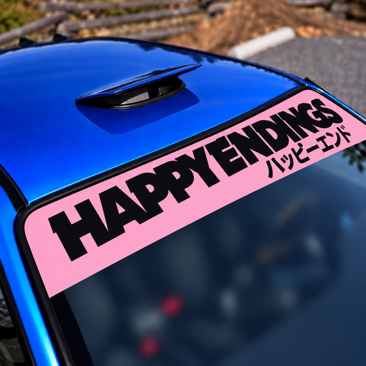 A pink windshield banner reads HAPPY ENDINGS with Japanese text on a blue car.