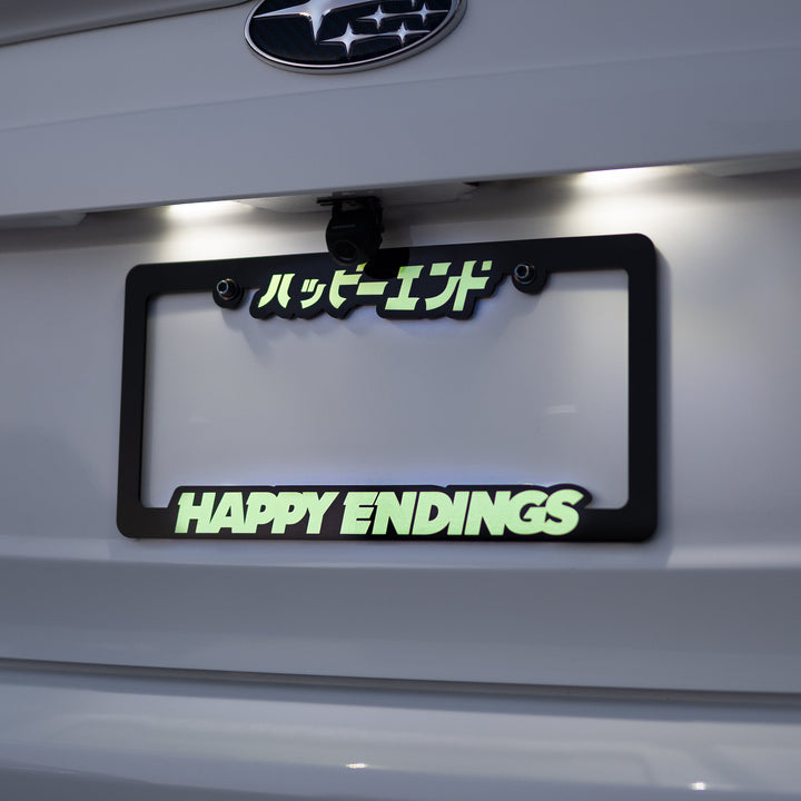 License Plate Frame - Glow in Dark (Black Frame) - Happy Endings - Automotive & Lifestyle Brand