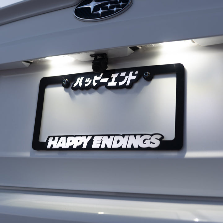 License Plate Frame - Glow in Dark (Black Frame) - Happy Endings - Automotive & Lifestyle Brand